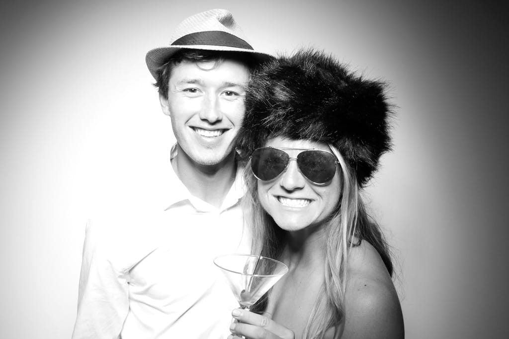 photo booth couple with props and furry hat