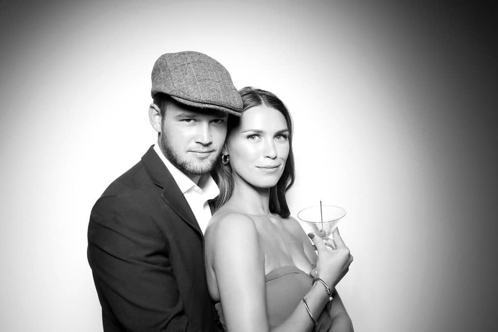 A glam portrait style photo booth photo of a couple standing close
