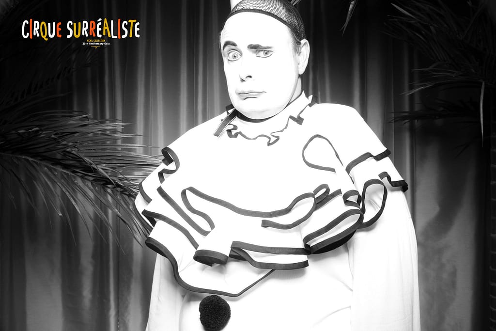 black and white glam photo booth image of a vintage clown with a sad face