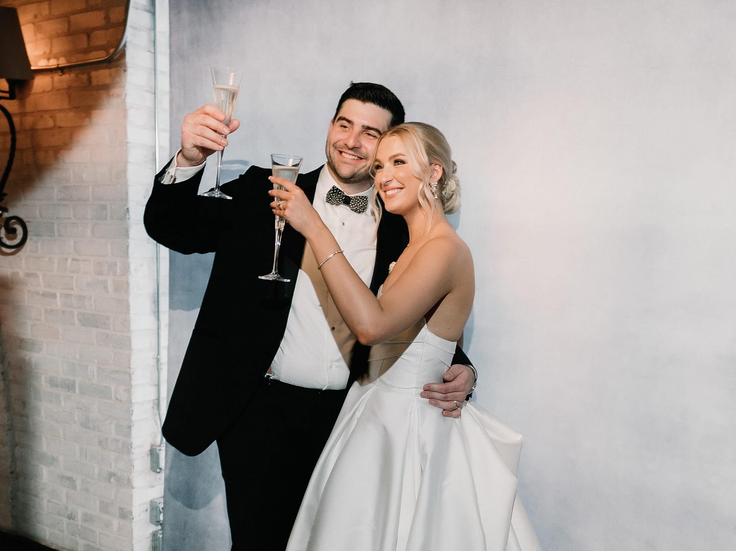 A bride and groom using a luxury fotably wedding photo booth