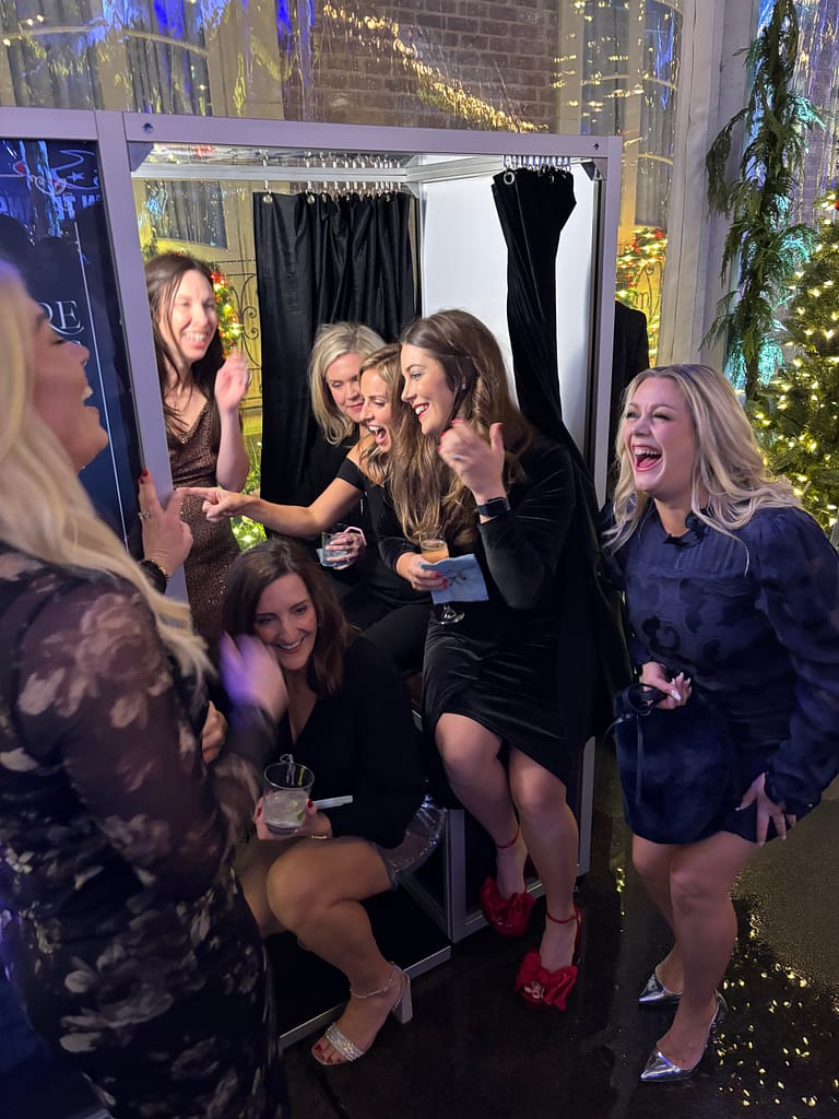 Guests using custom Enclosed Photo Booth in Houston