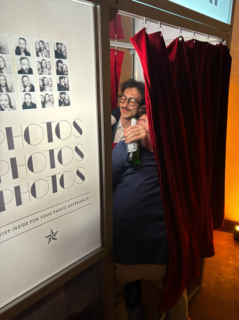 People inside enclosed photo booth rental in Houston